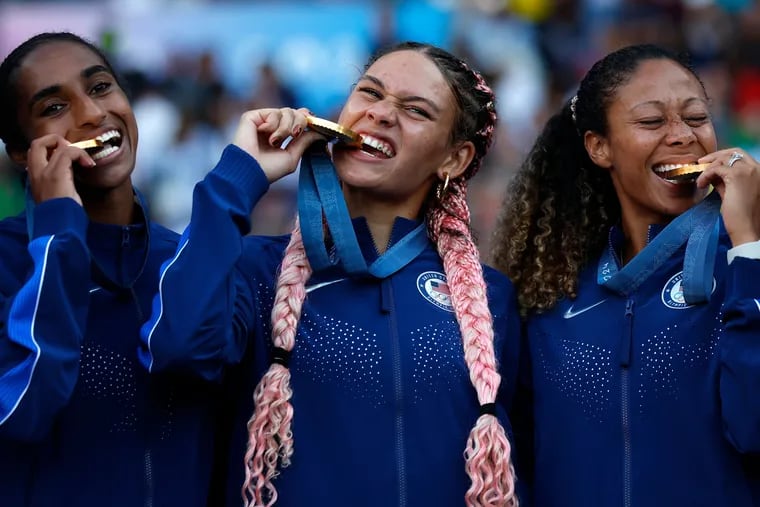 Trinity Rodman (center) and teammates Naomi Girma (left) and Casey Krueger (right) celebrating with their gold medals in Paris.