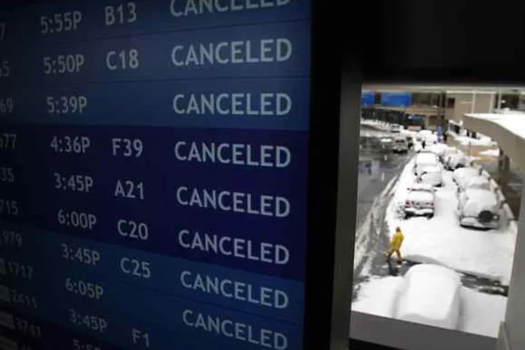 A blizzard of cancellations on an information board at Philadelphia International Airport.