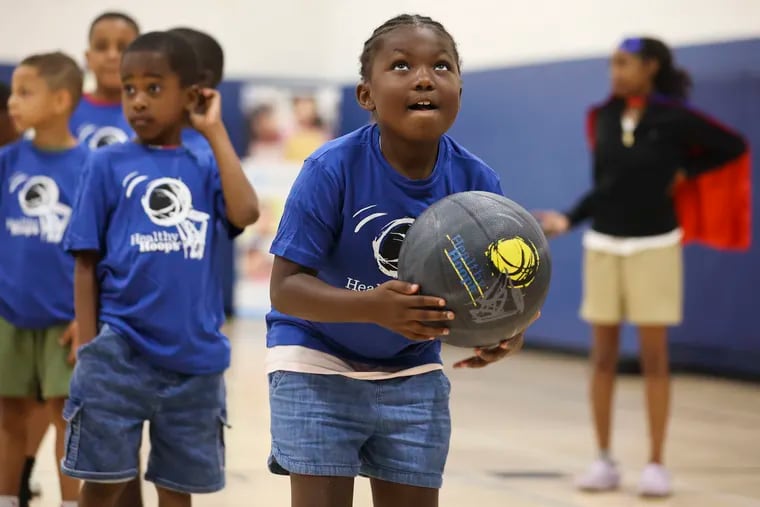 Nyla shoots a basketball during a Healthy Hoops event.