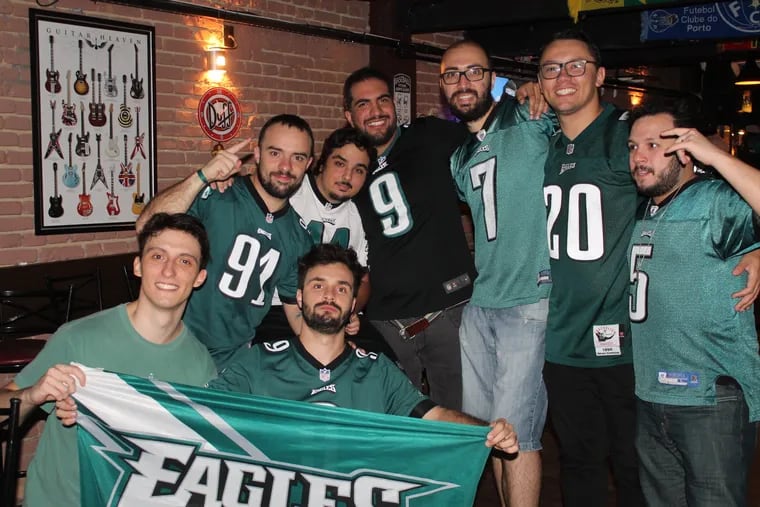 Members of the Eagles Brasil group, including Renan Oliveira (center,  No. 9 Nick Foles jersey) and Alexandre Branco (left of center, No. 91 Fletcher Cox jersey), meet up at a watch party for Super Bowl LII in 2018 in São Paulo.