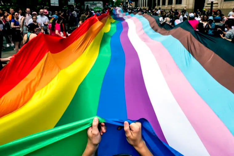 Marchers carry a 400-foot-long rainbow Pride flag — the largest in Philadelphia history — on June 2, 2024.