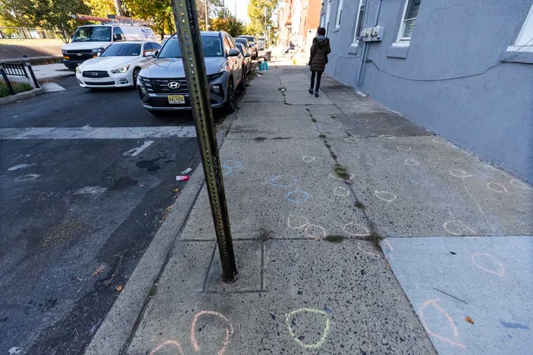 Chalk circles mark where bullet casings fell during two drive-by shootings early Saturday morning in North Philadelphia's Hartranft neighborhood, near Cumberland and 11th Streets, where seven people were wounded, two critically.