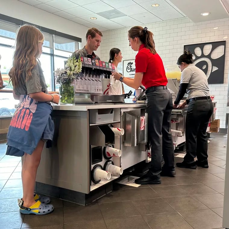 Workers serve customers at a fast food restaurant in southeast Denver on Thursday, June 27, 2024.