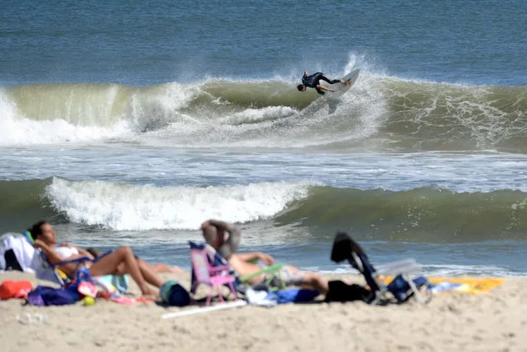 A surfer navigates huge swells from Hurricane Cristobal in 2014 on Long Beach Island. Cristobal tracked offshore, as Ernesto is forecast to do, and swimming was restricted on some beaches.