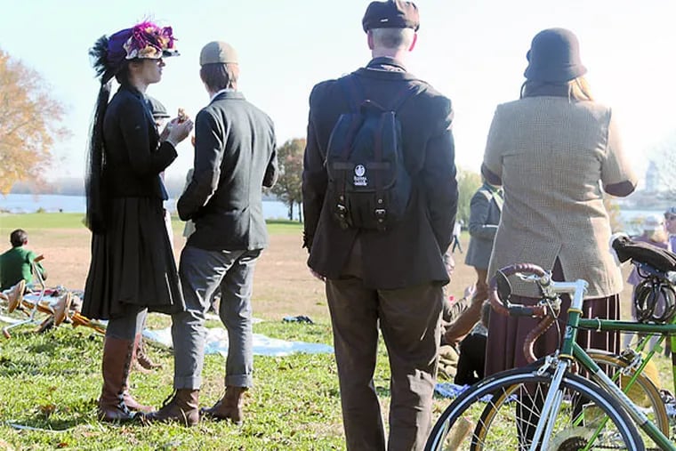 Attendees of the 5th annual tweed ride lounge in their apparel before their bike ride. ( RYAN S. GREENBERG / Staff Photographer )