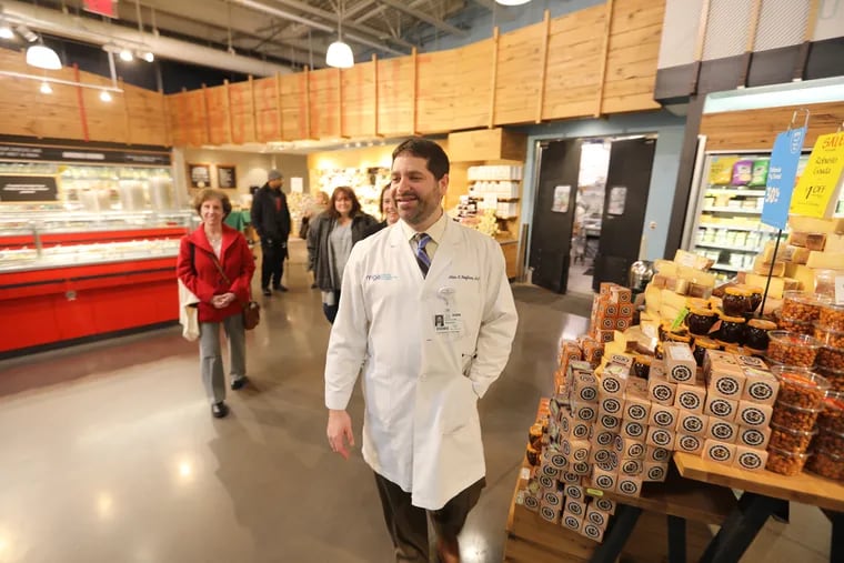 Adam Kaufman, gastroenterologist with Main Line Health, leads a tour at Whole Foods in Wynnewood, answering shoppers questions about healthy food choices.