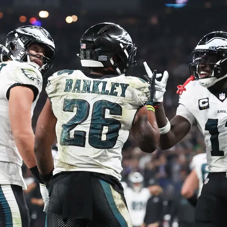 Eagles receiver A.J. Brown (right) congratulating Saquon Barkley during the opener. Brown will sit out Monday night with a hamstring injury.