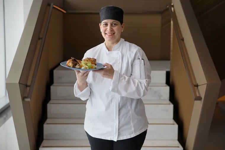 Ligia Richter, a chef in the employee cafeteria, stands for a portrait with a plate of special Cinco de Mayo dishes at the Four Seasons Hotel in Center City Philadelphia on Wednesday, May 5, 2021. Richter created the special meal for hotel workers using recipes from her mother and grandmother.