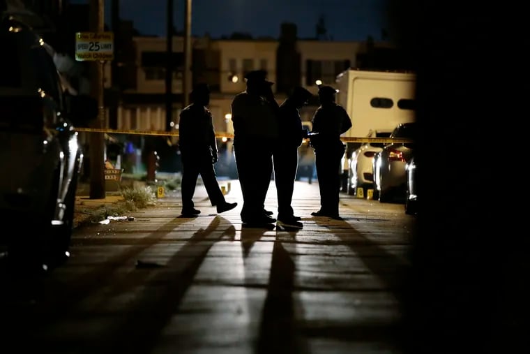 Philadelphia Police document the crime scene on the 2600 block of Carroll St. in Philadelphia where a 21-year-old man was killed and five others were injured in a drive-by shooting just after 8 p.m. on July 28, 2019.