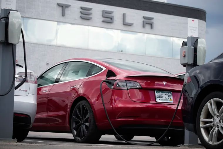 A 2021 Model 3 sedan sits in a lot at a Tesla dealership in Littleton, Colo.