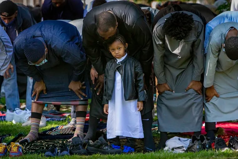 Abu Ridhwan and son Abu, 3, attend Eid Prayer together.