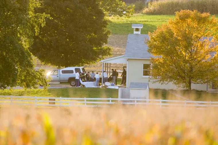 As evening falls over Lancaster County, medical personnel are at the one-room West Nickel Mines Amish School.