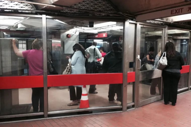 Passengers mill about PATCO's busy 8th and Market station about 8:30 a.m. Sept. 15, 2014 after being pulled from their trains or prevented from boarding after a woman was reportedly struck by a rail car. (Staff)
