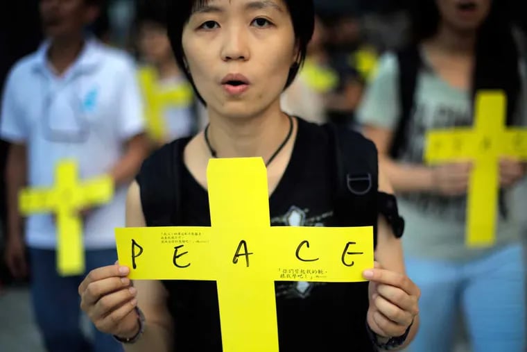 In Hong Kong, pro-democracy protesters pray for peace. When the Chinese government tried to censor big social media, marchers went to encrypted one-on-one messenger apps. (WONG MAYE-E / Associated Press)
