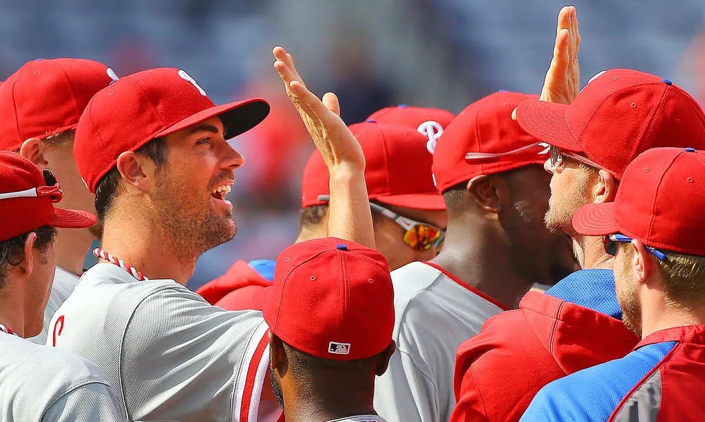 Hamels high-fives teammates after the first combined no-hitter in Phillies history. 