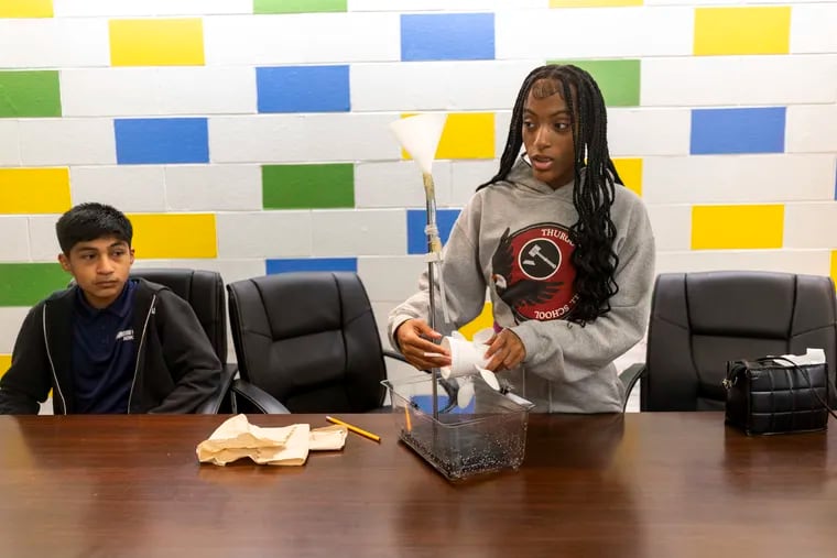 Jayla Blount, 13, an eighth grader, shows a water wheel her class built at Thurgood Marshall Elementary School in Olney.