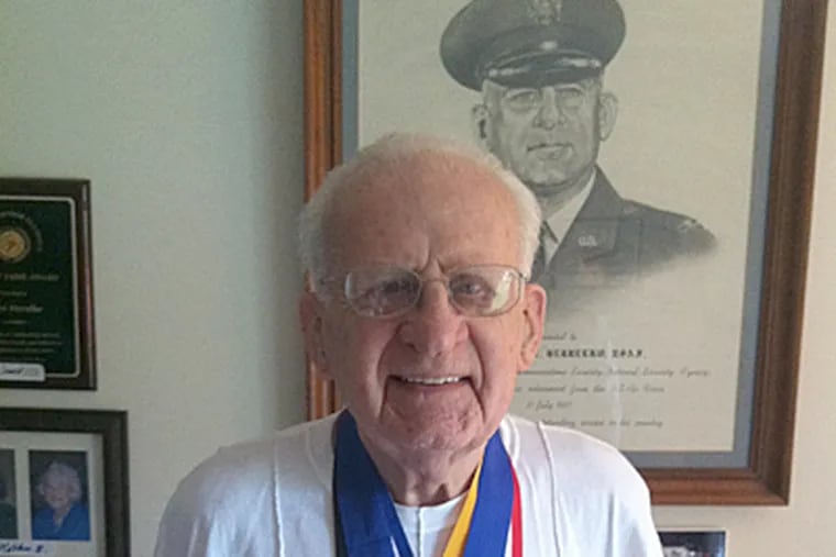 Frank Herrelko, 98, of Lower Gwynedd, with some of the 350 medals he has won in senior athletic competition. (Art Carey / Staff)