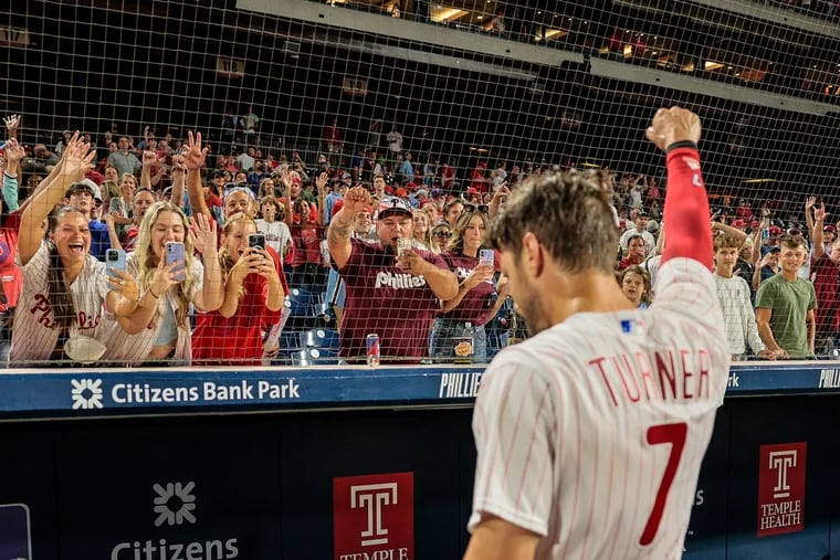 Phillies fans celebrate with Trea Turner after his walk-off base hit against the Giants in August 2023.