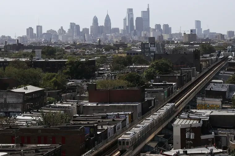 The Philadelphia skyline is seen behind an eastbound SEPTA train on the Market-Frankford line.