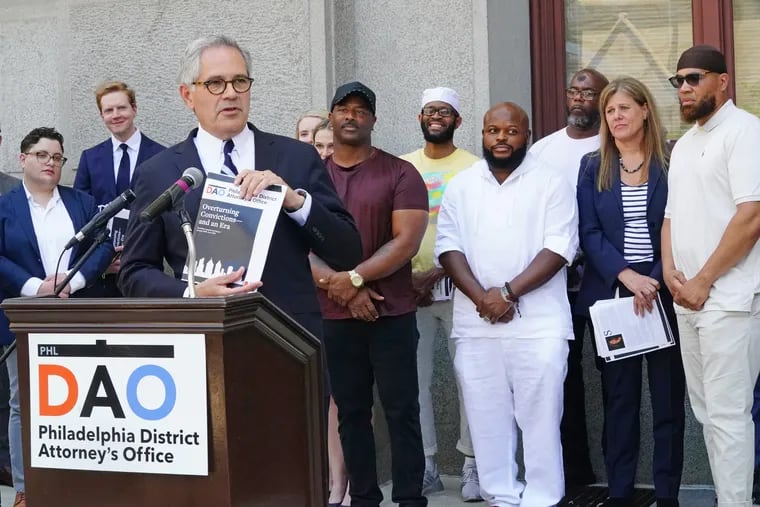 District Attorney Larry Krasner speaking at a 2021 news conference about the work his office had done to secure exonerations. He spoke while standing before a group of men whose convictions had been overturned with help from Krasner's office.