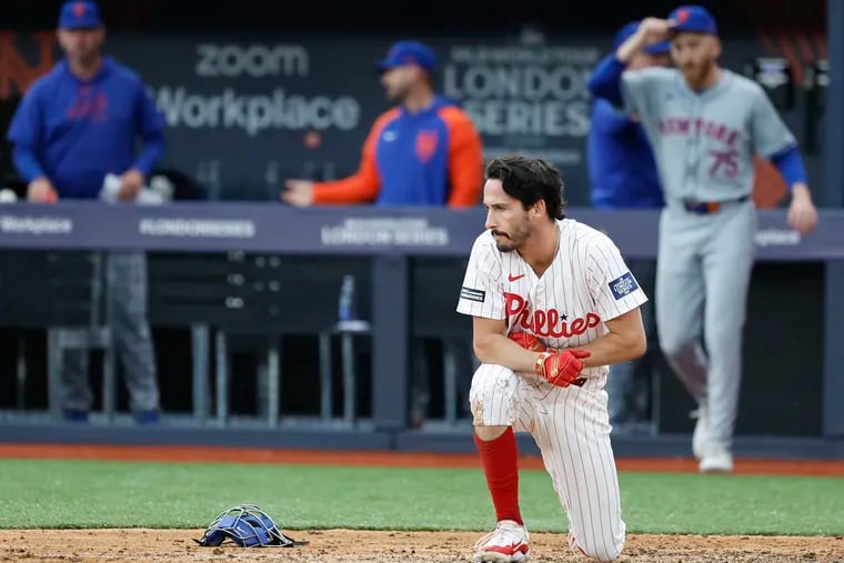 Phillies pinch runner Garrett Stubbs kneels near home plate after getting forced out on the game-ending play in the ninth inning against the Mets.