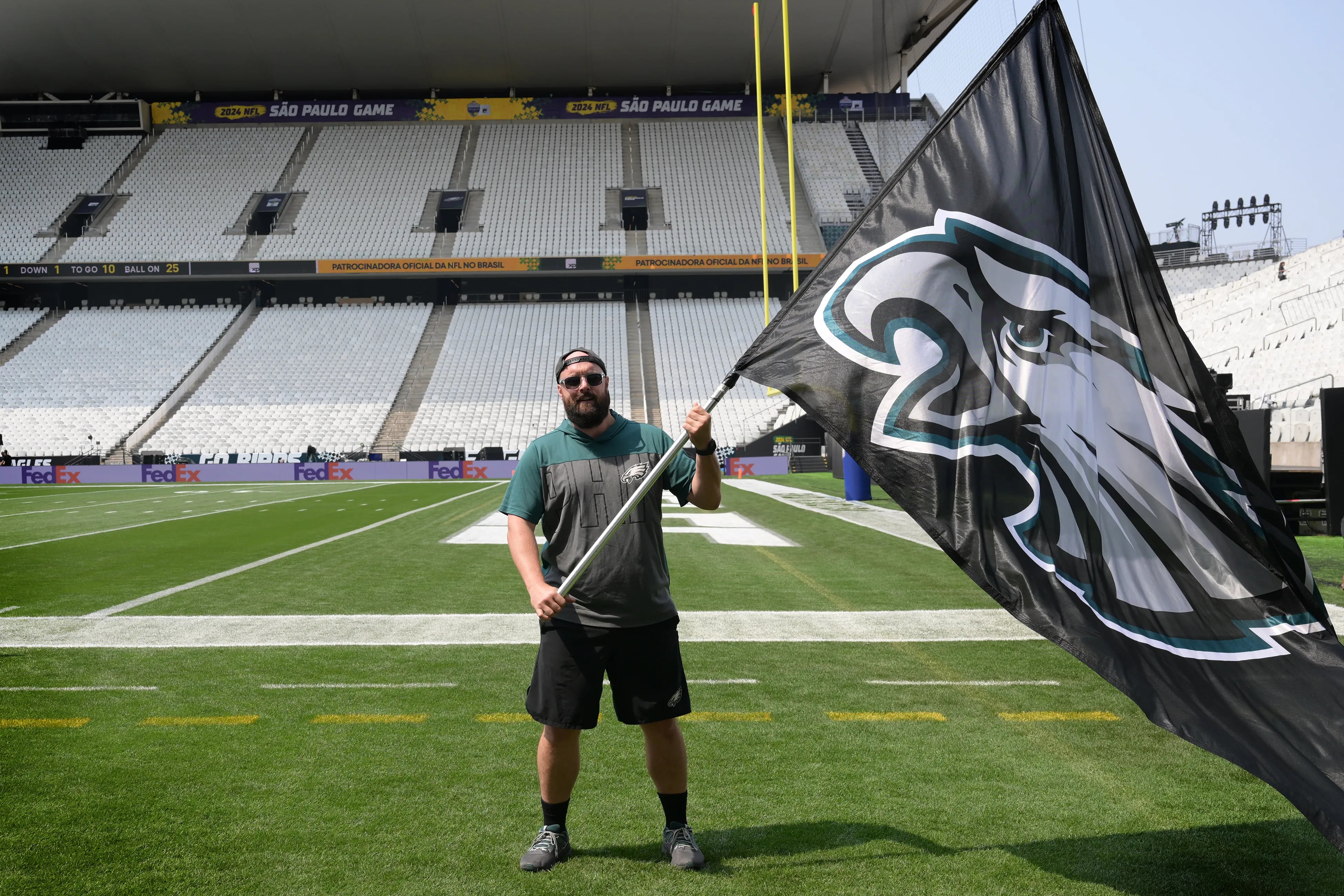 Kevin di Girolamo, an Eagles staffer, flies the Eagles flag Thursday at Corinthians Arena in São Paulo, Brazil.