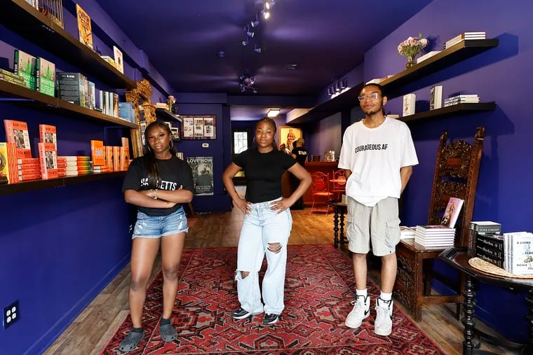 From left, Imani Wilson, 14, Serenity Glenn, 15, and Elijah Slayton, 20, inside Harriett's Bookshop in Fishtown on Monday, August 5, 2024.  The three are spending the summer working at Harriett's Bookshop and learned what it takes to be a bookseller.