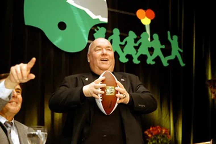 Former Eagles general manager Jim Murray prepares to throw a football at the Eagles Fly for Leukemia Bert Bell Memorial Award Dinner, which raised $140,000.