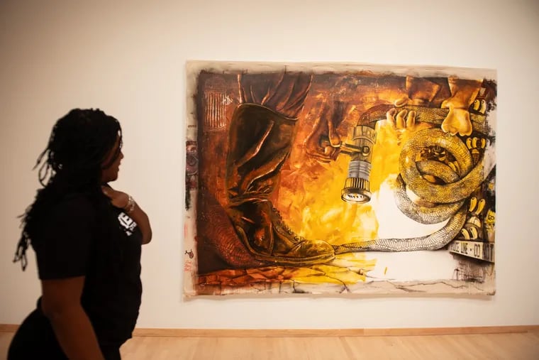 Keia Carter Simmons, associate director at Temple Contemporary, gives a tour of a new exhibit at Temple University on Thursday, Aug. 29, 2024. The exhibit is called, “Black Like That: Our Lives As Living Praxis.” This painting is by artist Pat Phillips, called "Stand Down."