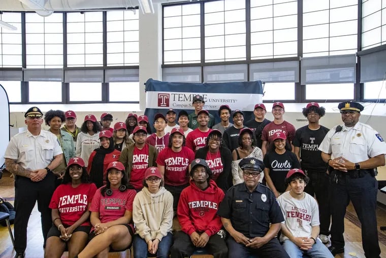 Temple University Officer Leroy Wimberly (first row, second from right) with most of the record-setting 42 George Washington Carver High School of Engineering and Science students who will attend Temple as first-year students in the fall. Wimberly has spent significant time at the school, and some Carver students say he's the reason they chose Temple.