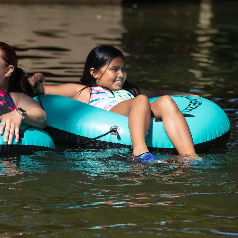 Soledad Navarro and her daugher Natalie cool off tubing in the West Branch of the Brandywine River in at the ChesLen Preserve in Newlin Township, Chester County on July 23, 2022.