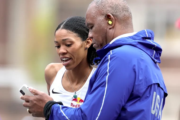 Vashti Cunningham conferring with her father, Eagles great, Randall Cunningham, during the Penn Relays on April 27.