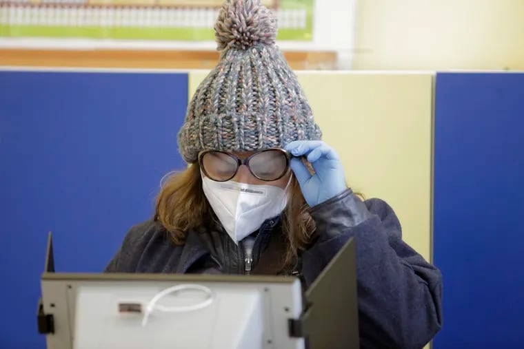 This woman's glasses fogged up as she voted in Bulgaria's April 2021 election, likely due to moist, exhaled breath that escaped from the top of her mask.