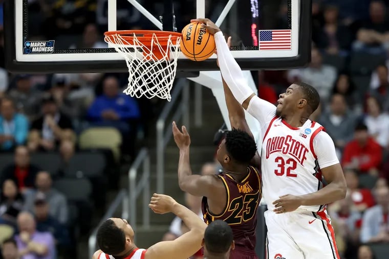 E.J.Liddell, right, of Ohio St. blocks a shot by Chris Knight of Loyola Chicago during the 1st half of their game in the NCAA Tournament n March 18, 2022 at PPG Arena in Pittsburgh, PA.