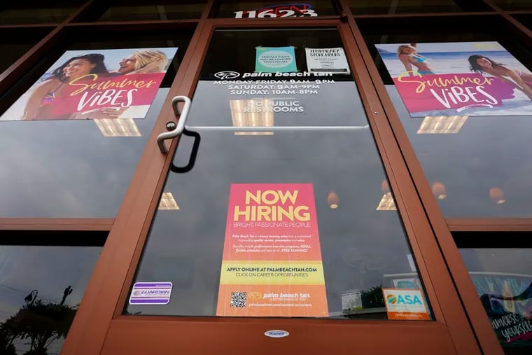 A Now Hiring sign at a business in Richmond, Va., Wednesday, June 2, 2021.  (AP Photo/Steve Helber)