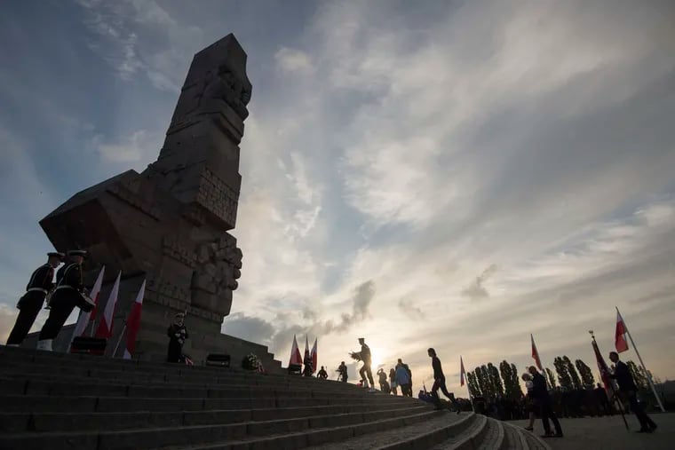 People lay a wreath at the monument to the 1939 heroic defense of the Westerplatte peninsula outpost during solemn observances of the 85th anniversary of the outbreak of World War II, at Westerplatte, on the Baltic Sea, Poland. Attacked by a German Nazi warship in the small hours on Sept. 1, 1939, the Westerplatte military outpost was supposed to hold out for 24 hours, but its soldiers put up resistance to the Germans for seven days.