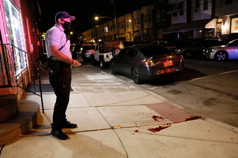 Philadelphia Police look for evidence as they investigate a double shooting that occurred at 22nd and Jackson streets shortly before 7 pm on Sunday.