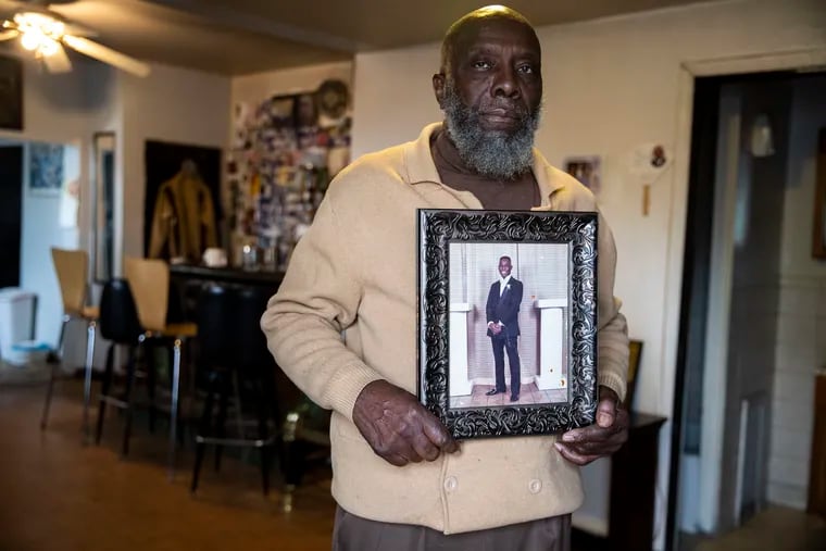 Ralph Brown holds a prom photo of his son Darren Brown, who was fatally shot in June 1990 by Derrick Ragan, who had killed another person 11 days earlier.