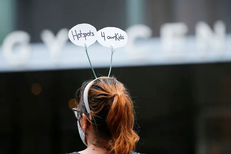 Anna Reed wears her "Hotspots 4 Our Kids" antenna during a protest at the Comcast Technology Center in Center City on Monday, August 3, 2020.  Internet access for students has become more crucial as schooling goes remote during the coronavirus pandemic, writes Philadelphian and Syrian refugee Nasr Sadar.