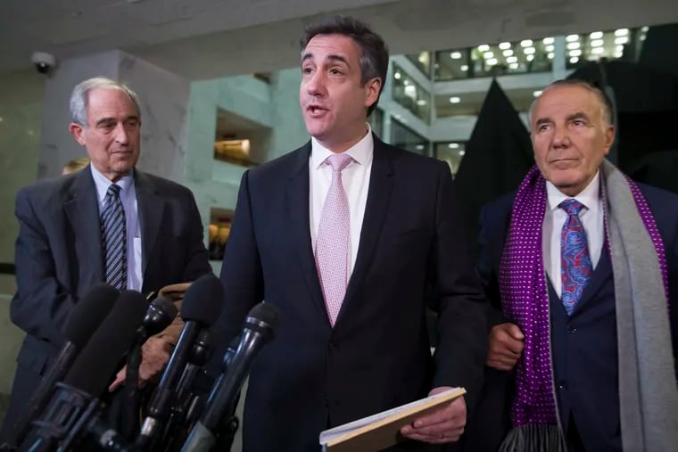 Michael Cohen (center), accompanied by his lawyers, Lanny Davis (left) and Michael Monico.