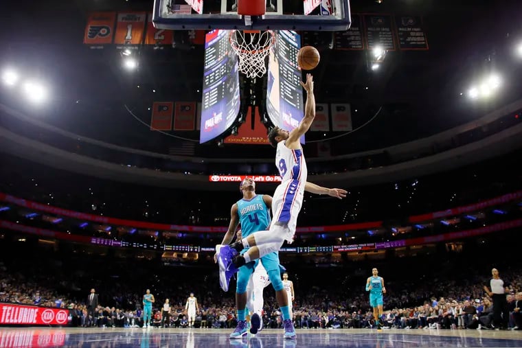Raul Neto goes up for a shot in front of the Hornets' Devonte Graham during the first half. The Sixers point guard is making the most of his playing time.