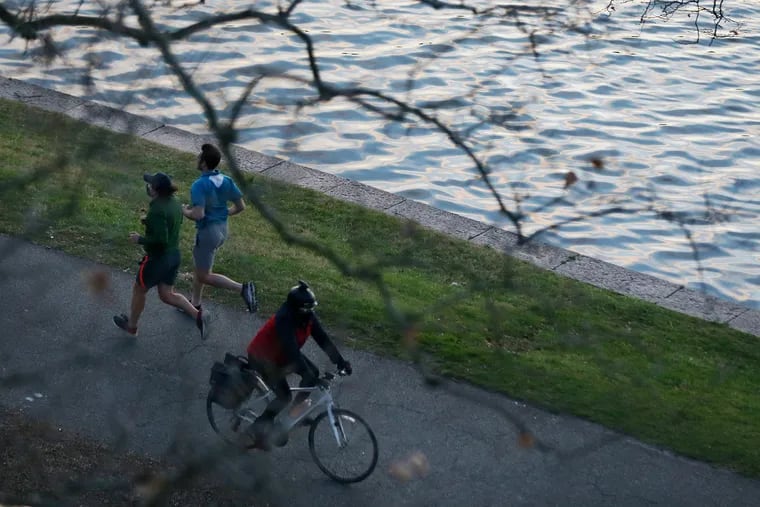 People exercise along Kelly Drive and the Schuylkill in Philadelphia.