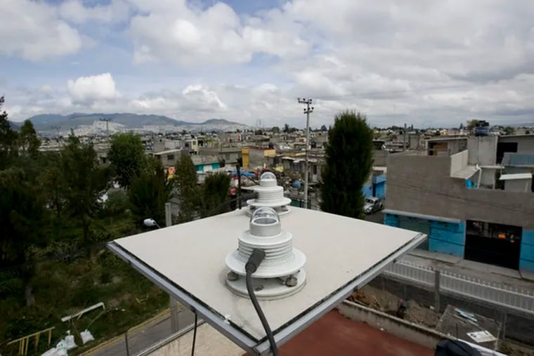 sits on a Mexico City rooftop. Efforts to reduce pollution intensified in the early 1990s.