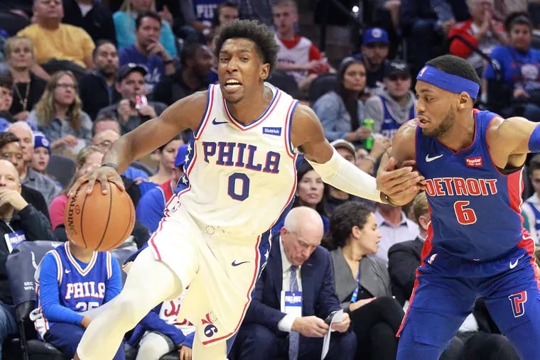 Josh Richardson, left, of the Sixers drives to the basket against Bruce Brown of the Pistons during the 1st half of their NBA preseason game at the Wells Fargo Center on Oct.15, 2019.