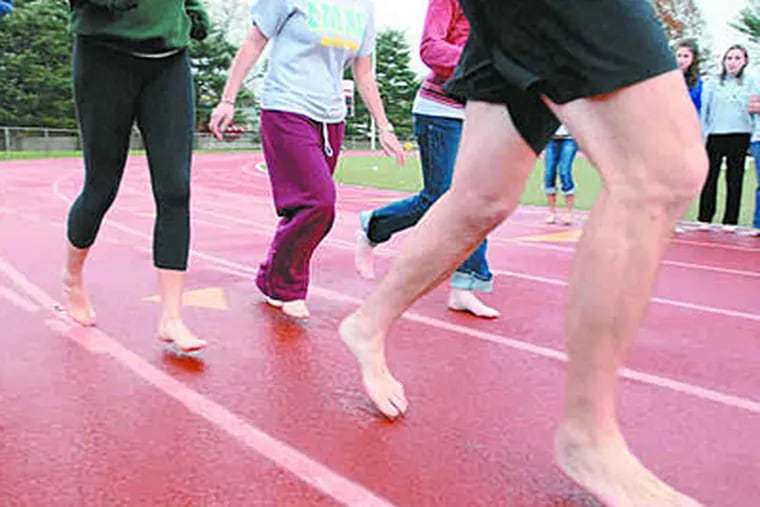 Leading the charge, Christopher McDougall and girls from Lower Merion High take a test run. (Ron Tarver / Staff)