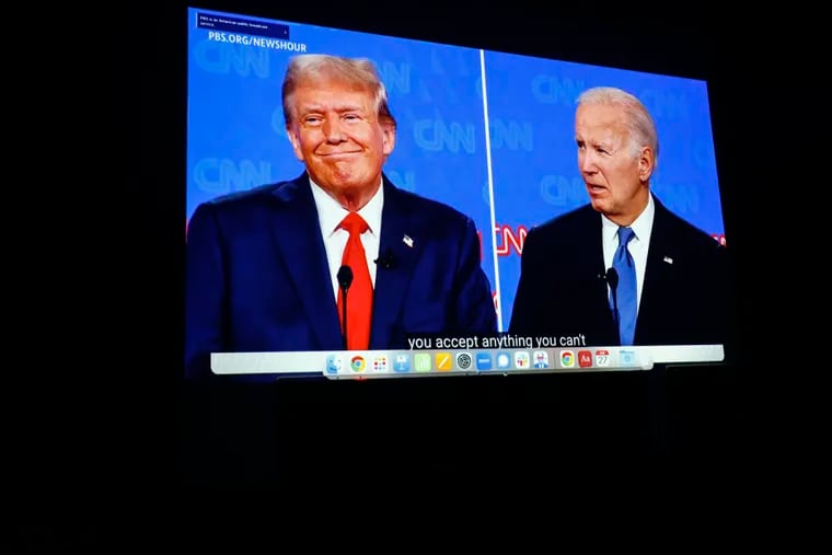 A screen plays the debate between President Joe Biden and former President Donald Trump at the Biden campaign's Roxborough office on Thursday night.