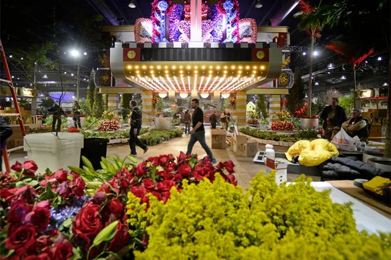 Workers from Valley Forge Flowers work on the Art Deco theater facade in the entryway Thursday, February 26, 2015 as they prepare for opening of Philadelphia Flower Show and its 2015 theme - "Celebrate the Movies."