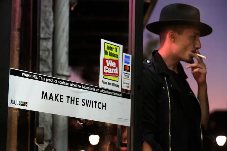 Jon Sheairs of Phila. smokes a American Spirits tobacco cigarette outside of a vape shop on South St. in Phila., Pa. on September 26, 2019. Researchers at UPenn are sharing a nearly $10 million grant to study whether public health messaging can convince smokers to start using lower-risk tobacco products without nudging non-smokers to do the same.