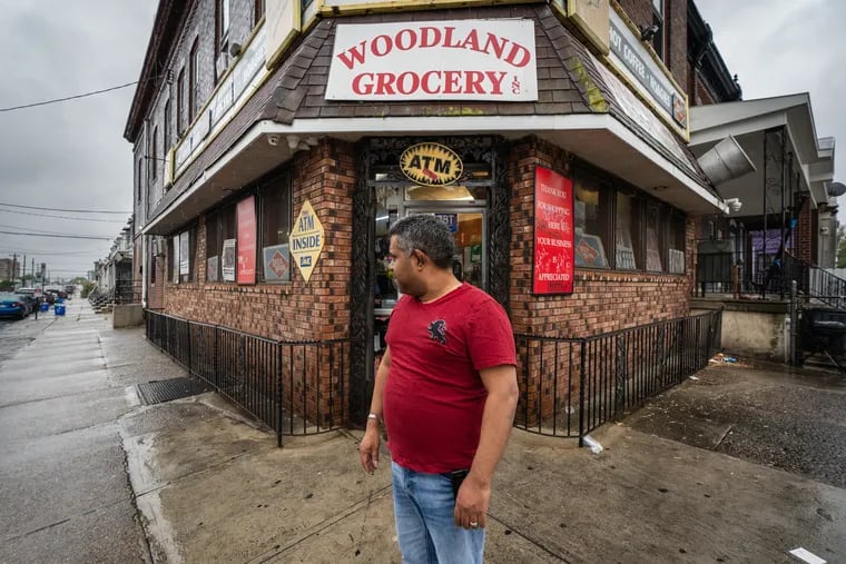 Guillermo Herrera, owner of Woodland Grocery, looks back towards the 2200 block of South 67th Street, where a 16 year-old boy was shot Thursday evening.