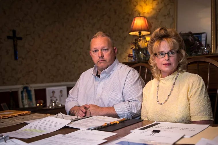 Angelique and Ira Smith in 2016 sit in front of documents and files from a defamation case that lasted more than seven years before being dismissed.